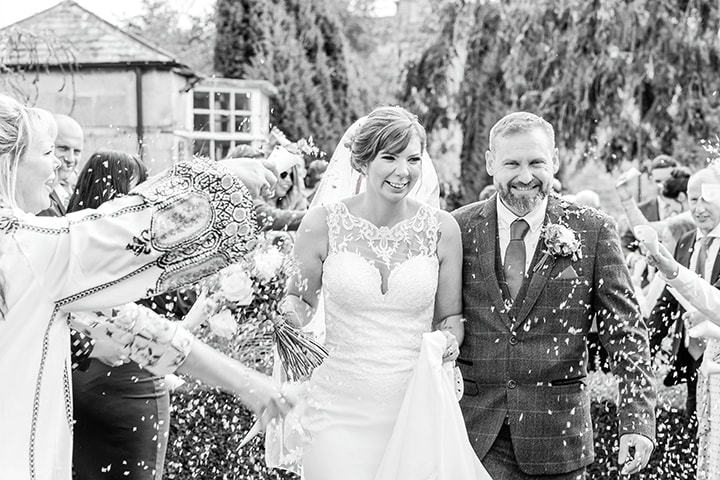 Confetti throwing, bride and groom portraits in Cotswold house hotel and spa garden.