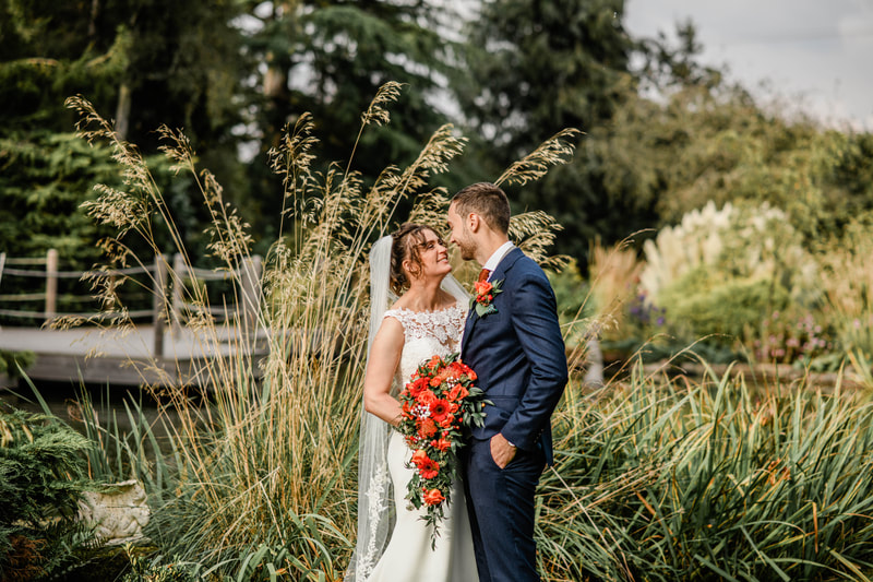 Redhouse barn, bride and groom by the pond